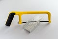 Yellow hand saw and aluminium miter box for hobby in home workshop Royalty Free Stock Photo
