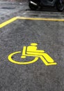 Yellow handicap sign in a parking Royalty Free Stock Photo