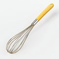 Single Kitchen Whisk with Yellow Handle on White Background Royalty Free Stock Photo