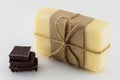 Yellow handmade soap and chocolate on white background