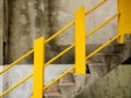 yellow handrail of a concrete staircase
