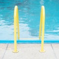 Yellow handrail poolside