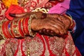 The yellow hands of the bride by the pandit at an Indian wedding