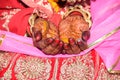 The yellow hands of the bride by the pandit at an Indian wedding