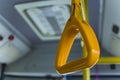 Yellow  hanging handhold for standing passengers in a modern bus. Suburban and urban transport Royalty Free Stock Photo