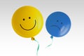 Yellow happy balloon and blue sad balloon flying away on white background - Prevalence of positive over negative mood conept Royalty Free Stock Photo