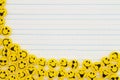 Yellow happy buttons border on lined paper