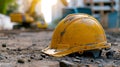 A yellow hard hat laying on the ground next to a construction site, AI Royalty Free Stock Photo