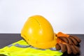 A yellow hard hat and leather work gloves . Royalty Free Stock Photo