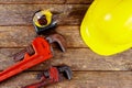 Yellow hard hat and leather work gloves and wrench construction Royalty Free Stock Photo