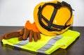 A yellow hard hat and leather work gloves . Royalty Free Stock Photo