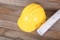 Yellow hard hat and rolled drawings for construction Royalty Free Stock Photo