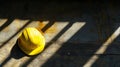 Yellow Hard Hat with Shadows on Wall in Construction Setting Royalty Free Stock Photo