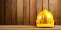 Yellow hard hat on wooden background with copy space. Construction concept. Banner 2:1 Royalty Free Stock Photo