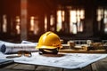 Yellow hard hat on a wooden table in front of a construction site Royalty Free Stock Photo