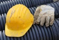 Yellow hard hat and work gloves in construction site Royalty Free Stock Photo