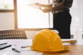 Yellow hard hat on workbench start plan contracting new project in construction office center and contractor concept