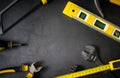 Yellow hardware tools on black concrete background with some space for text