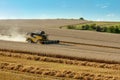 Yellow harvester combine on field harvesting gold wheat Royalty Free Stock Photo