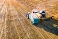 A yellow harvester is working in the field. Grain harvesting