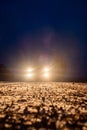 Yellow headlight and dirtroad in the dark after snowing. Car driving on a dangerous road in dire circumstances.