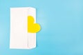 Yellow heart in white envelope isolated on blue background. Copy space Royalty Free Stock Photo