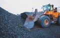 Yellow heavy excavator and bulldozer excavating sand and working during road works, unloading sand and road metal Royalty Free Stock Photo