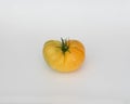 A yellow heirloom tomato isolated on white Royalty Free Stock Photo