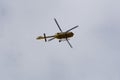 Yellow helicopter flying in the blue sky Royalty Free Stock Photo