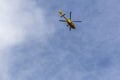 Yellow helicopter flying in the blue sky Royalty Free Stock Photo