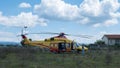 Yellow helicopter rescue operation for patient recovery from assigned ambulance and medical staff equipped for covid 19 Royalty Free Stock Photo