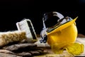 Yellow helmet and carpenter tools. Carpenter and old wooden table. Royalty Free Stock Photo