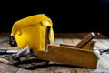 Yellow helmet and carpenter tools. Carpenter and old wooden table. Royalty Free Stock Photo