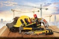 Yellow helmet for construction work and tools with a background crane Royalty Free Stock Photo