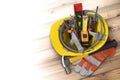 Yellow helmet for construction work and tools on the plank Royalty Free Stock Photo