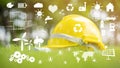 Yellow helmet on green with ecological icon Royalty Free Stock Photo