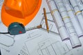 Yellow helmet, house keys and drawing tools on construction plans Royalty Free Stock Photo