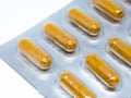 Yellow herb pills transparent gelatin capsule in blister pack