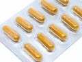 Yellow herb pills transparent gelatin capsule in blister pack