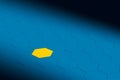 Yellow hexagon standing out from the crowd of blue hexagons Royalty Free Stock Photo