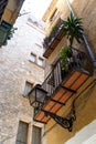 Yellow historic house with street light, flowers and balconies in Barcelona Royalty Free Stock Photo