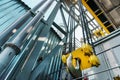 Yellow hook and chain of the factory bridge crane