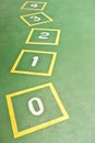 Yellow Hopscotch on Green Playground Royalty Free Stock Photo