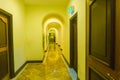 Yellow hotel corridor with many classical arches and decorative vines Royalty Free Stock Photo