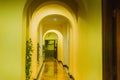 Yellow hotel corridor with many classical arches and decorative vines Royalty Free Stock Photo