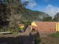 Yellow house of Aula de la Naturaleza with resting aera in mist laurisilva forest at the Garajonay National Park hiking