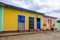 Yellow house with blue door and windows in Trinidad, Cuba