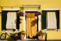 Yellow house, flowers and a bicycle in Burano, Venice, Italy