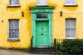 Yellow house with green front door Royalty Free Stock Photo