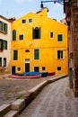 Yellow house and inner court with boats in Venice